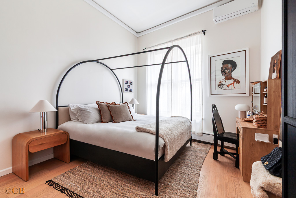 159 Carlton Avenue, Unit 4A Brooklyn, NY 11205 - Photo 4 of 9 a bedroom with a bed a couch and a potted plant on dresser