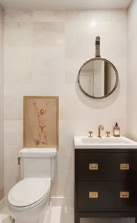 a bathroom with a toilet a sink and mirror