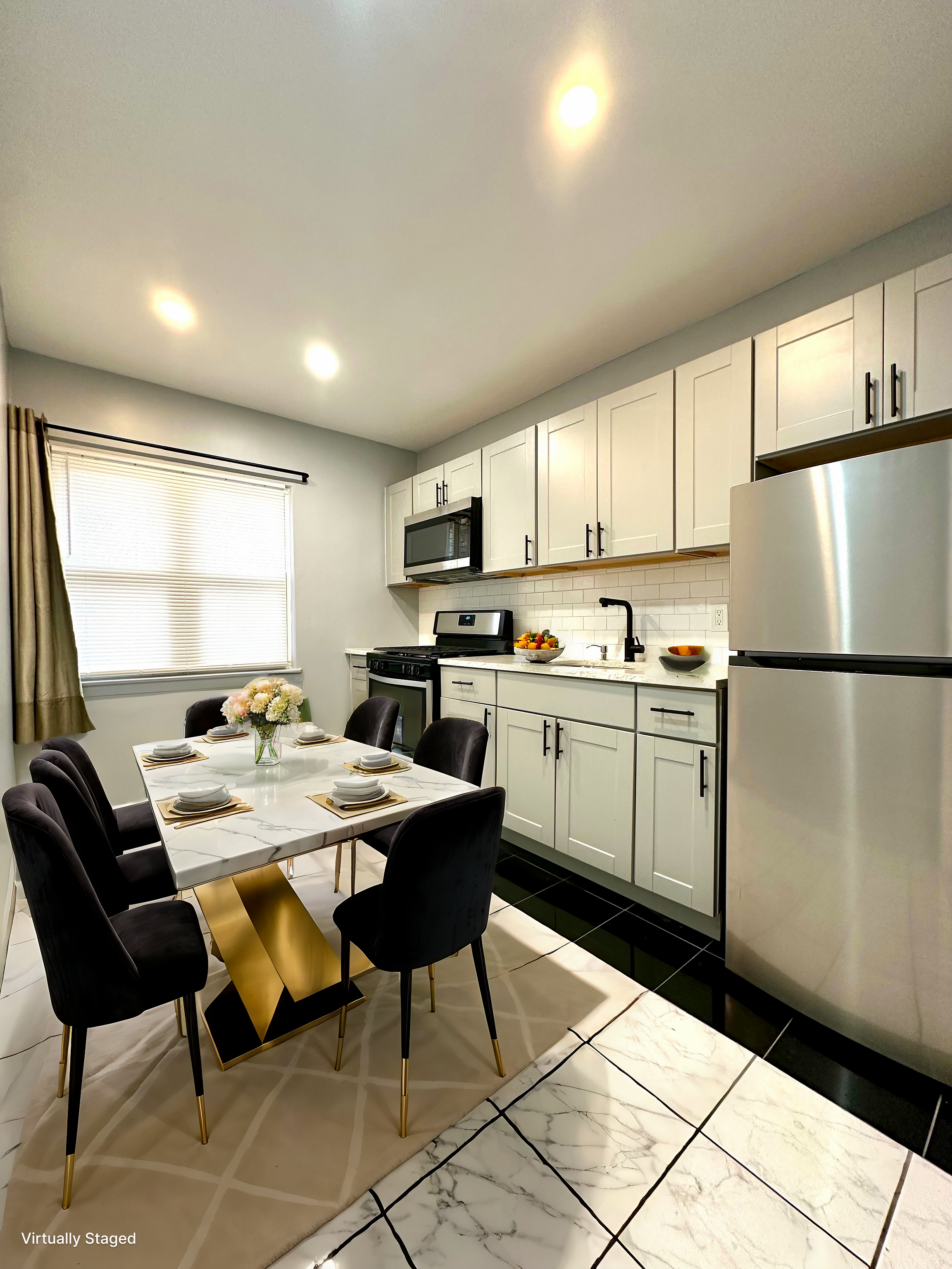 75-66 197th Street Queens, NY 11366 - Photo 10 of 14 a kitchen with a refrigerator a table and chairs