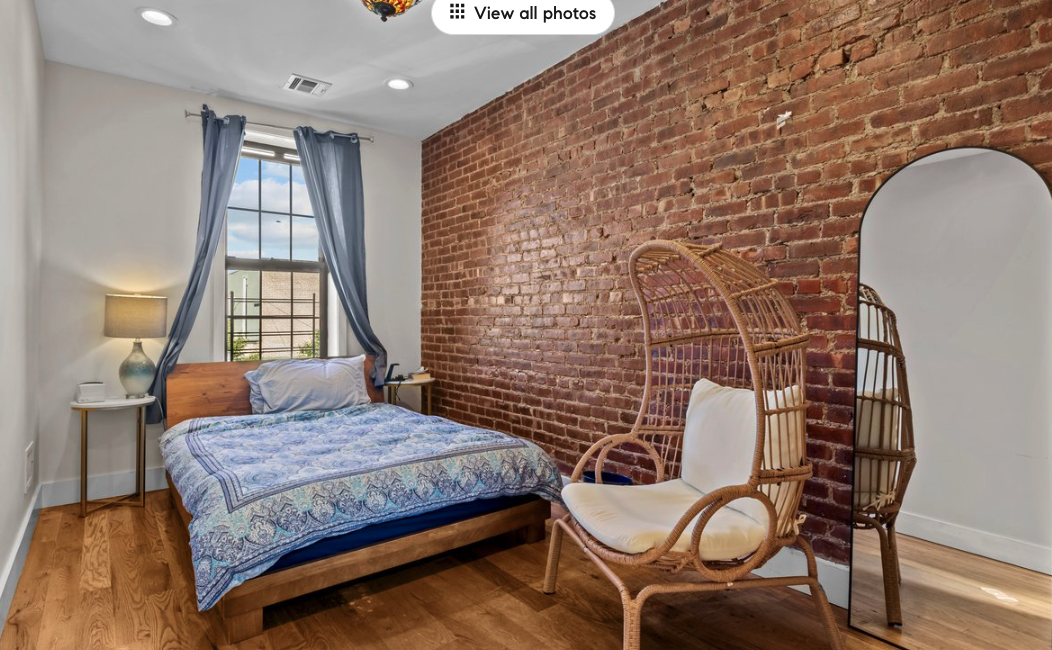 251 Troy Avenue Brooklyn, NY 11213 - Photo 4 of 9 a bedroom with a bed and wooden floor