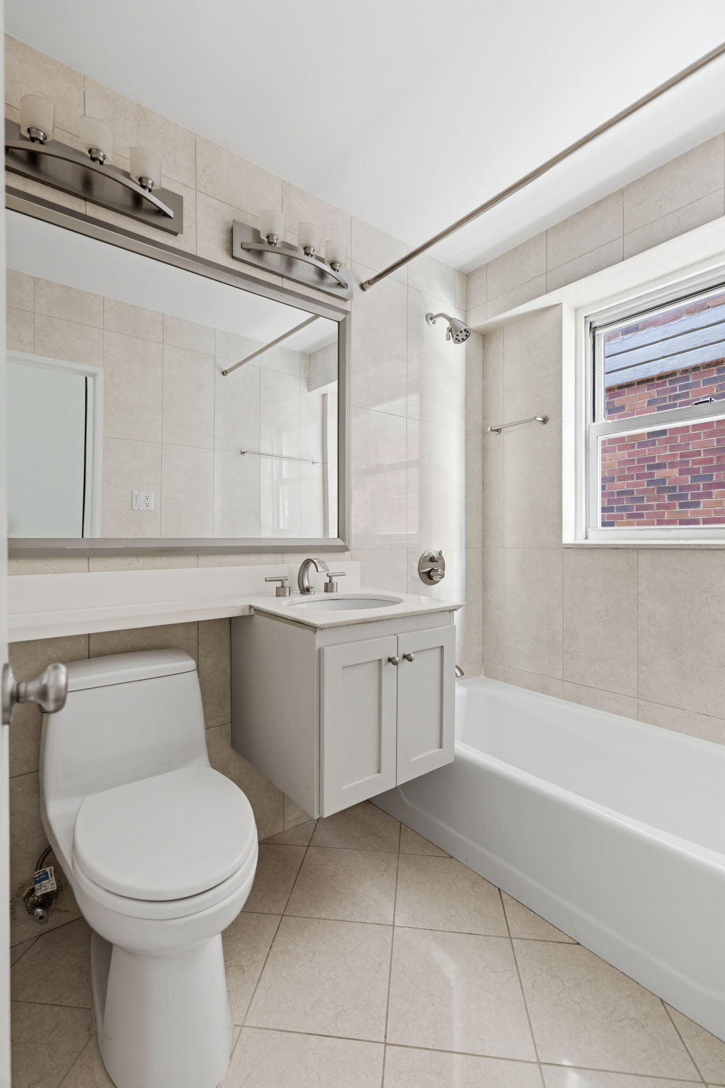 360 East 72nd Street, Unit A306 Manhattan, NY 10021 - Photo 14 of 17 a bathroom with a toilet sink and mirror