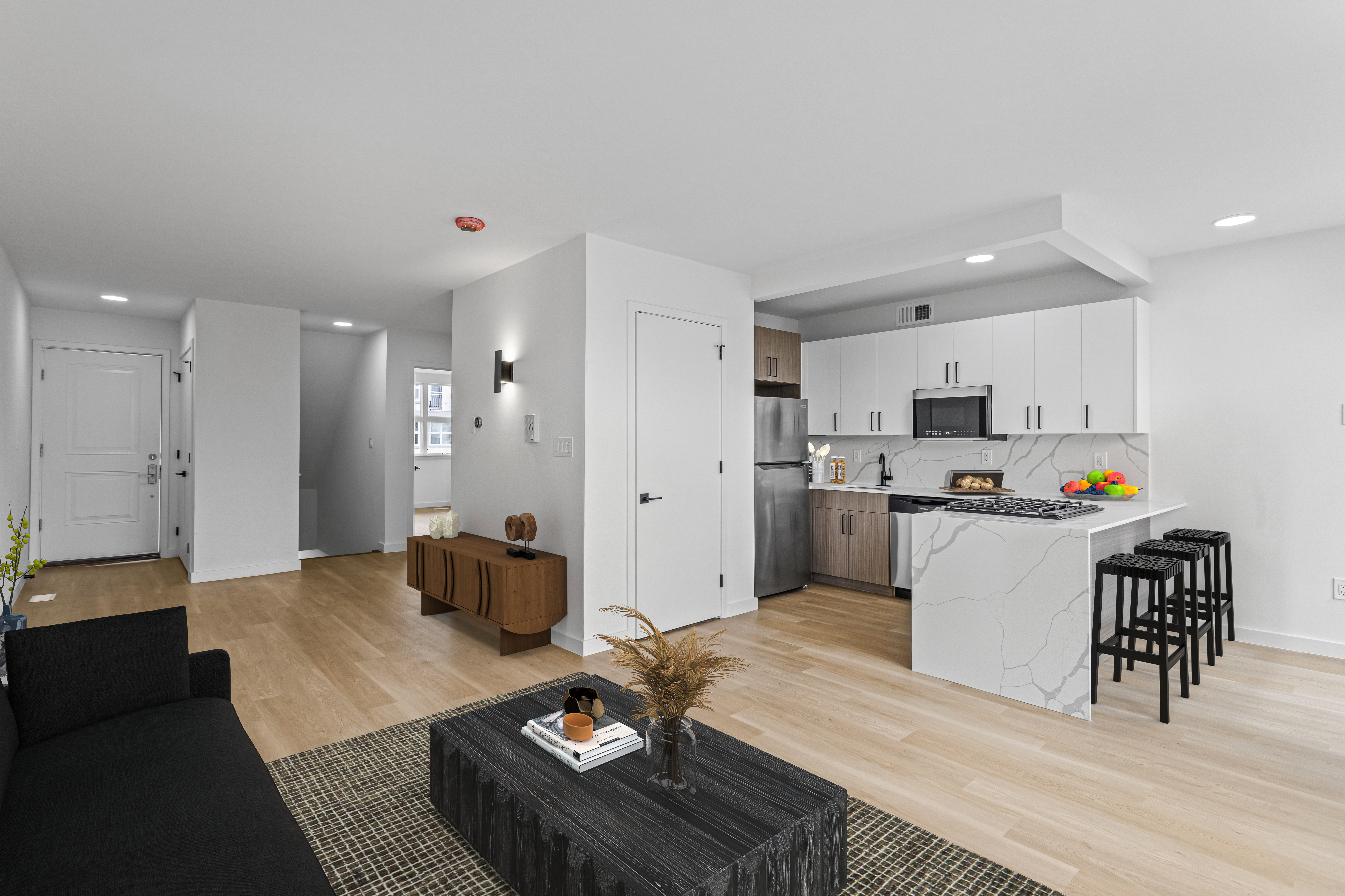 a living room with furniture and kitchen view