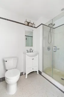 a bathroom with a toilet sink and shower