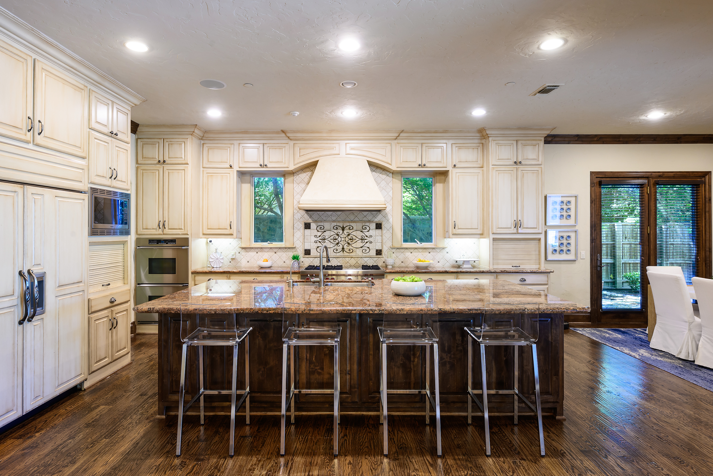 11503 West Ricks Circle Dallas, TX 75230 - Photo 14 of 39 a kitchen with stainless steel appliances granite countertop wooden floor and chairs