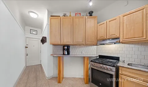 a kitchen with appliances a stove a sink and cabinets