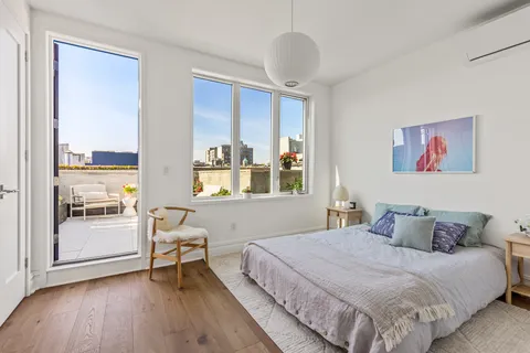 a bedroom with a large bed and a window
