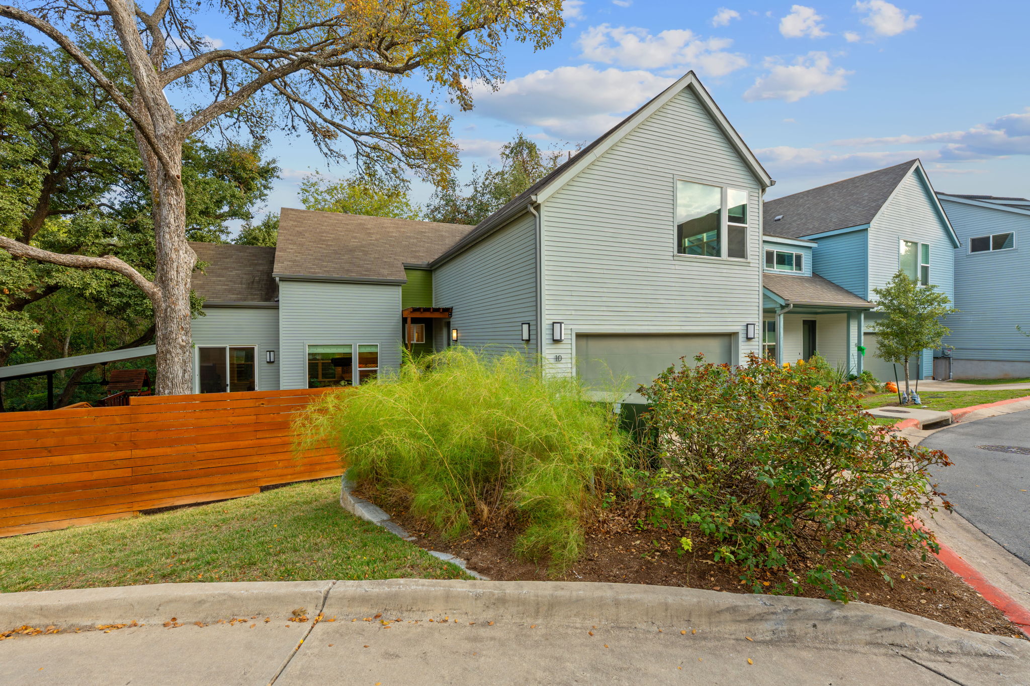 3001 Del Curto Road, Unit 10 Austin, TX 78704 - Photo 2 of 44 a front view of a house with a yard and potted plants