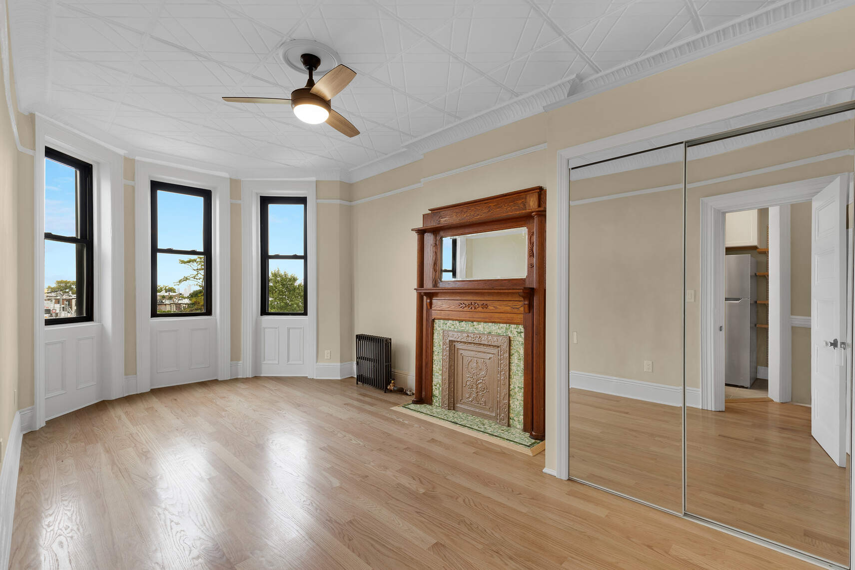 159 Prospect Park West, Unit 4 Brooklyn, NY 11215 - Photo 4 of 14 a view of empty room with wooden floor and fan