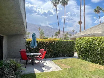 a view of a chairs and table in backyard