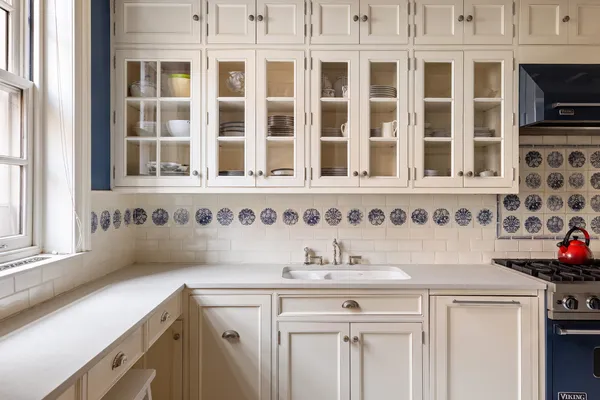 a kitchen with stainless steel appliances kitchen island granite countertop a refrigerator a stove a sink dishwasher a dining table and chairs with wooden floor