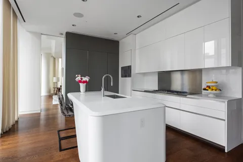 a kitchen that has a sink and a stove in it