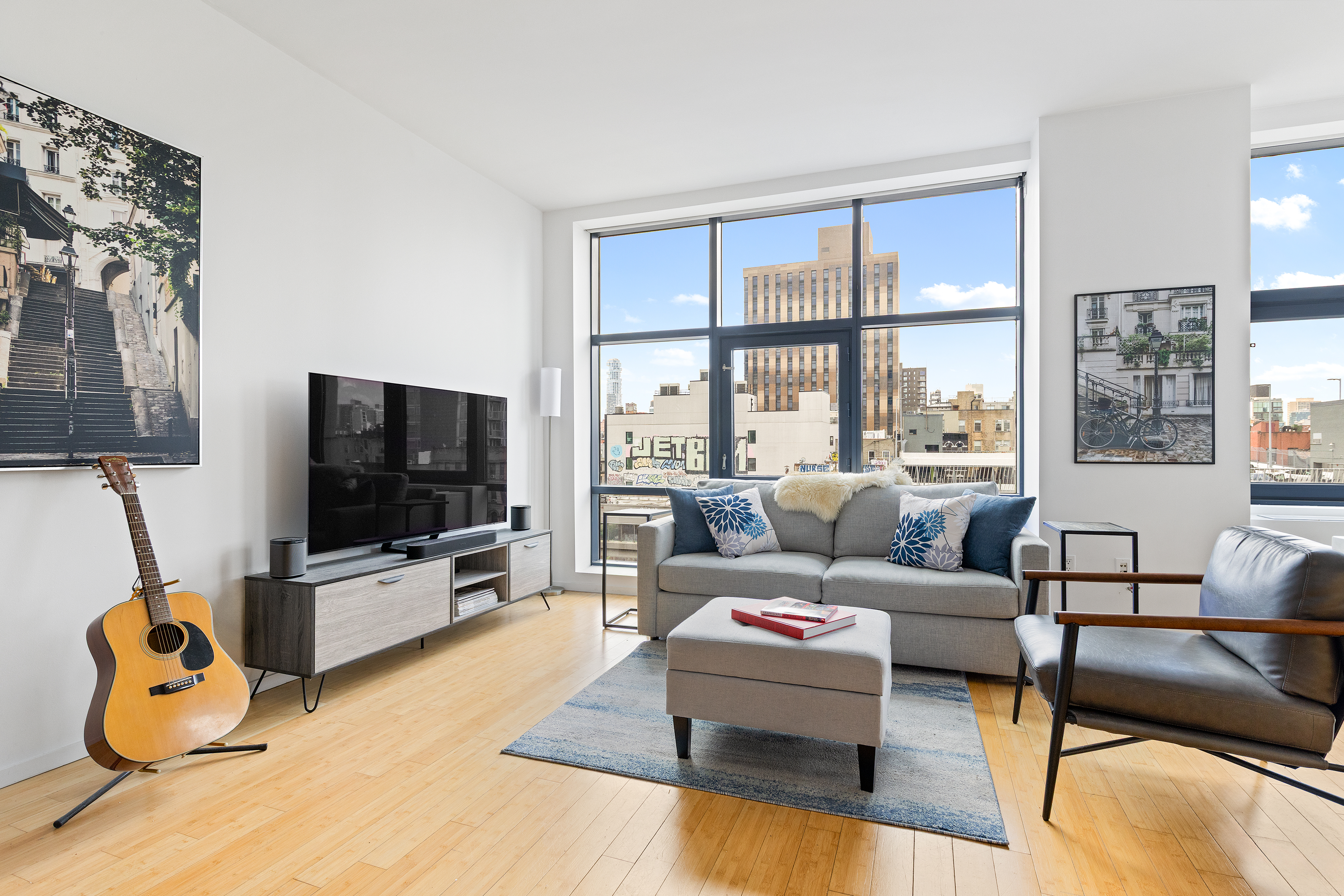 105 Norfolk Street, Unit 7A Manhattan, NY 10002 - Photo 2 of 14 a living room with furniture and a flat screen tv
