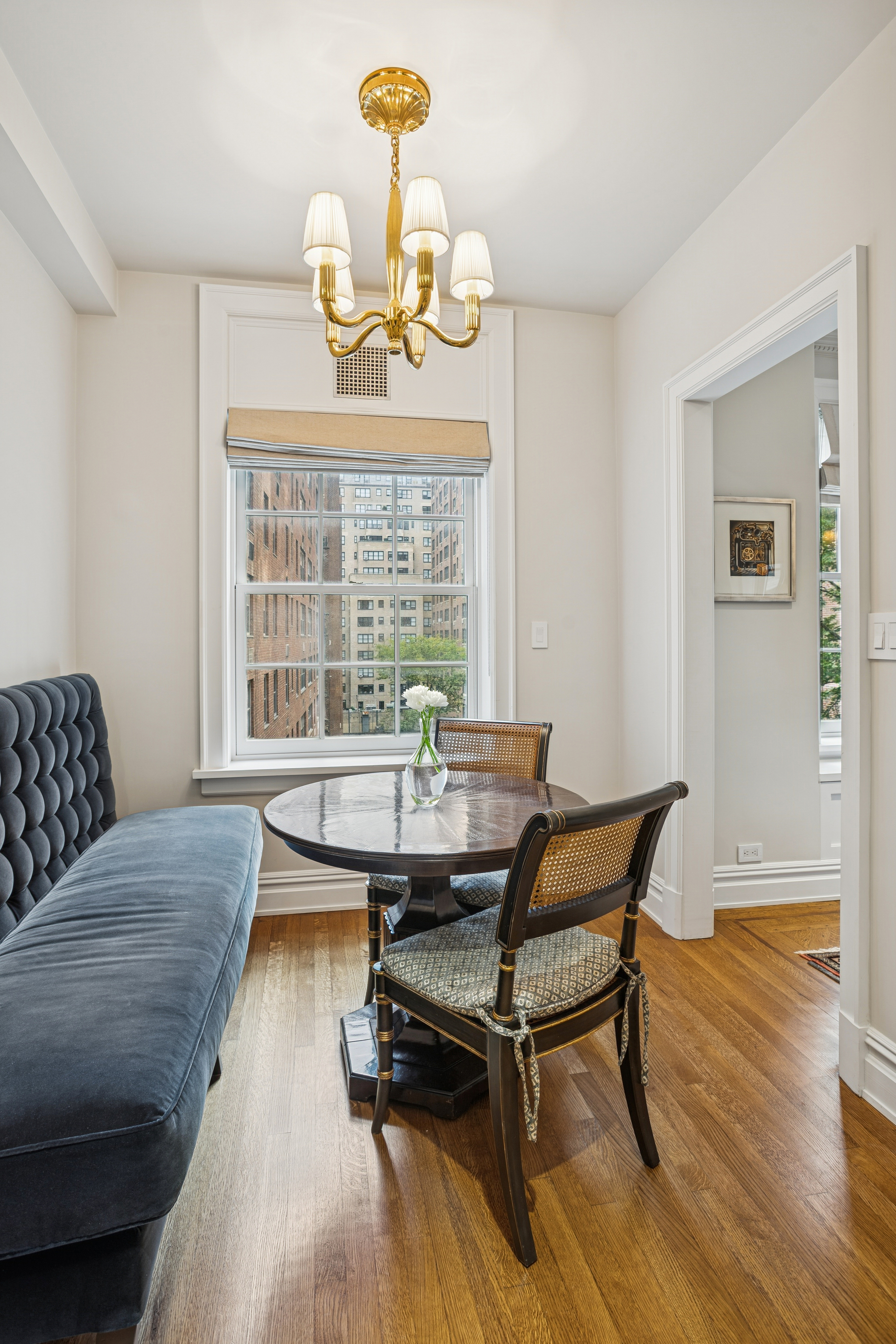 14 Sutton Place South, Unit 7G Manhattan, NY 10022 - Photo 4 of 9 a living room with furniture and a wooden floor