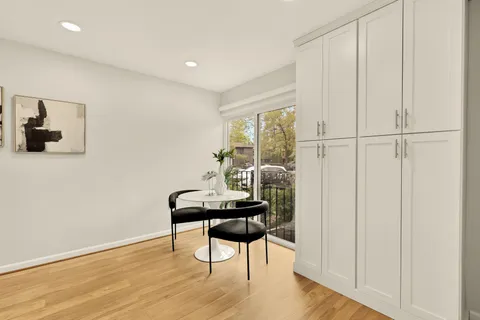 a dining room with furniture and wooden floor