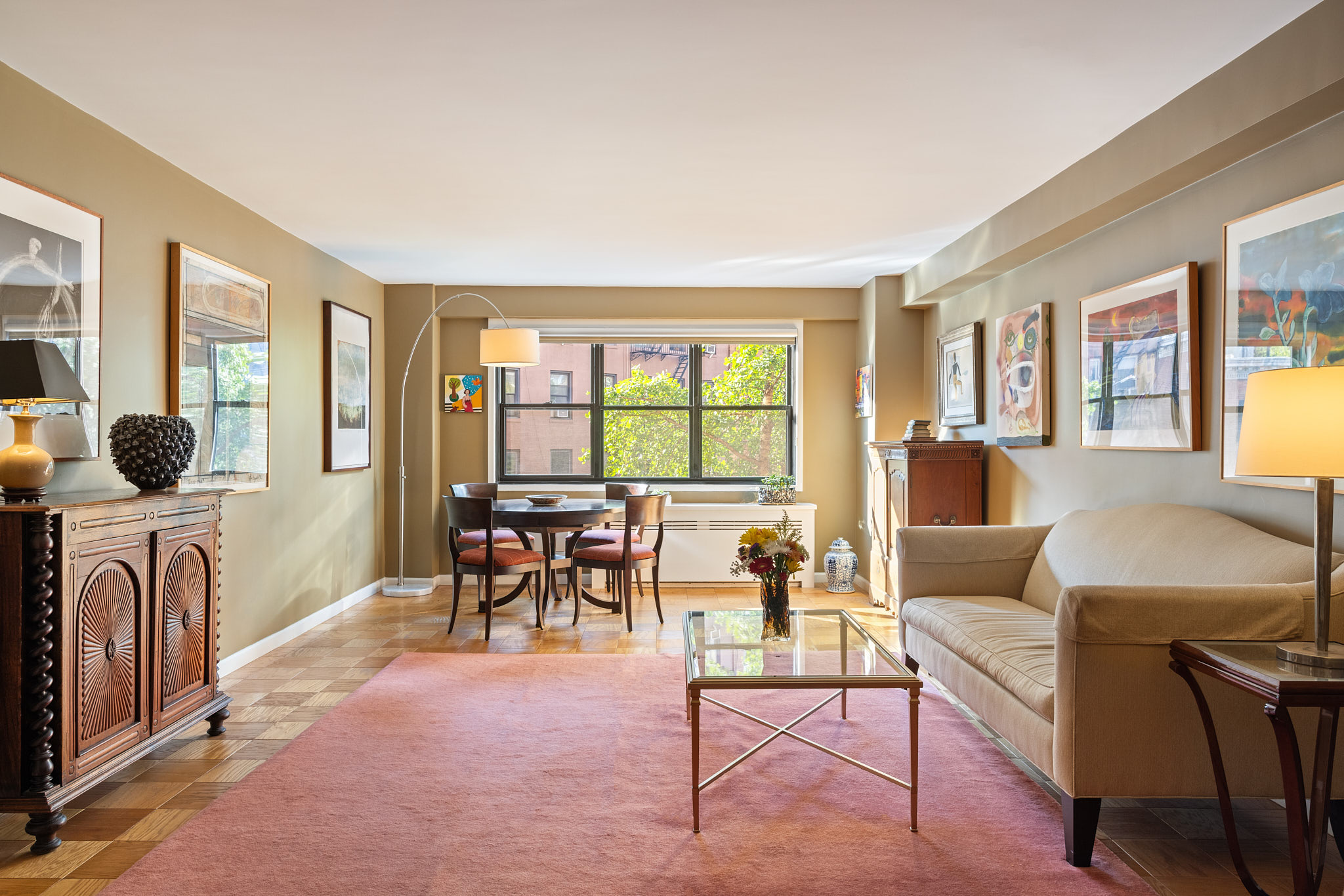 a living room with furniture and a floor to ceiling window