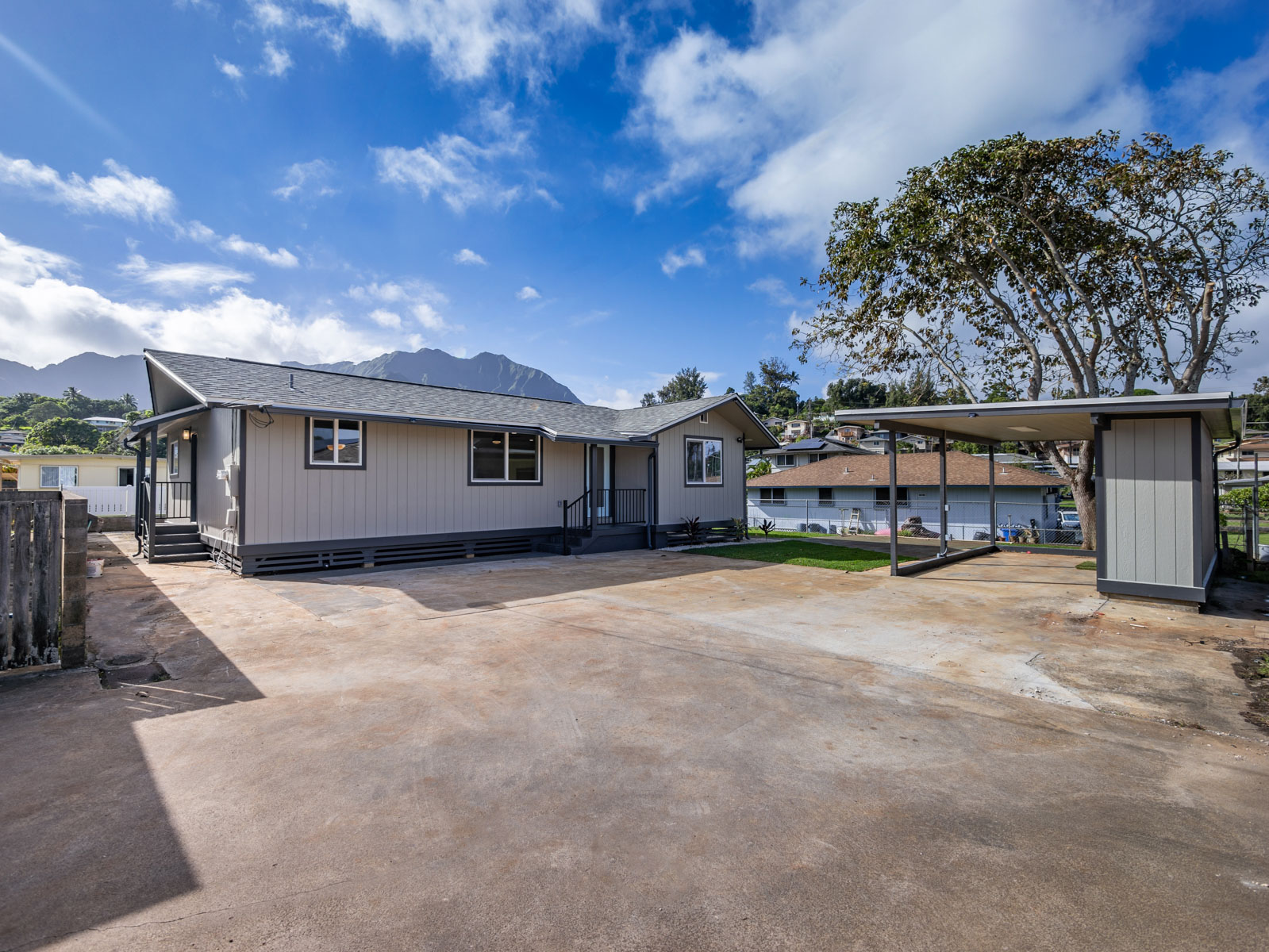 45-561 Paleka Road, Unit C Kaneohe, HI 96744 - Photo 24 of 27 a front view of a house with a yard and garage