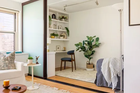 a view of living room with furniture and a potted plant