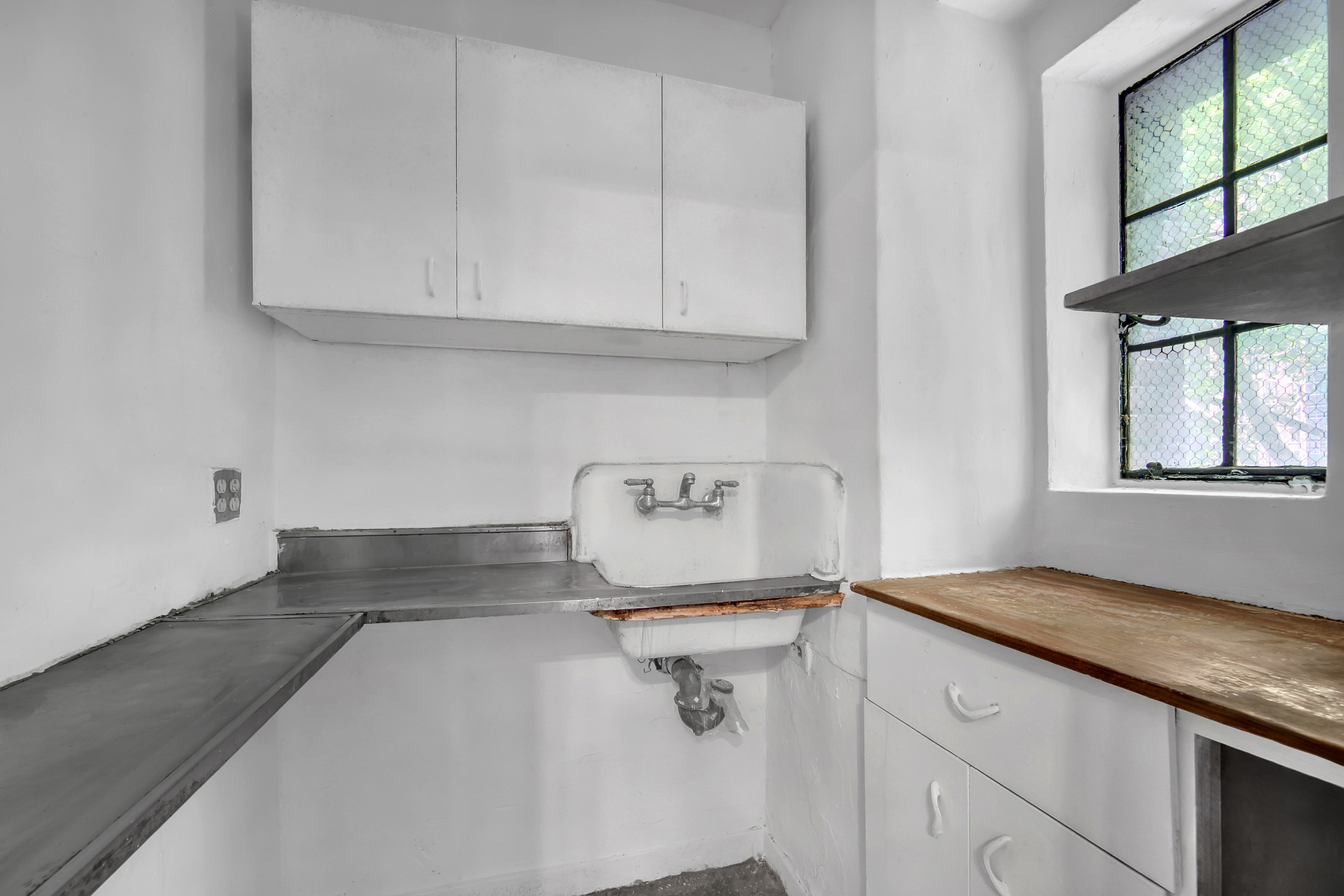 320 East 42nd Street, Unit 418 Manhattan, NY 10017 - Photo 6 of 10 a kitchen with a sink and cabinets