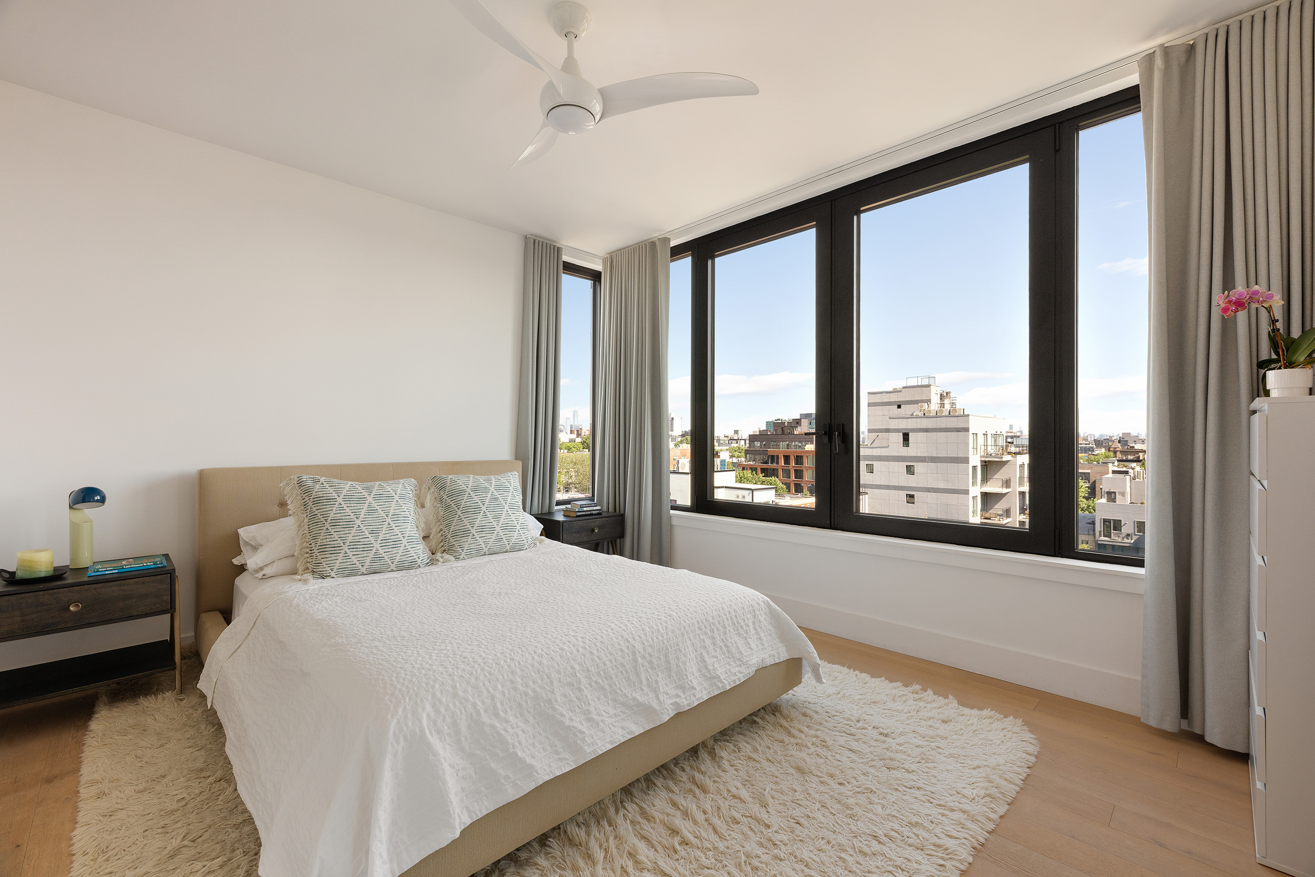 762 Park Place, Unit PH1 Brooklyn, NY 11216 - Photo 3 of 15 a bedroom with a large bed and a large window