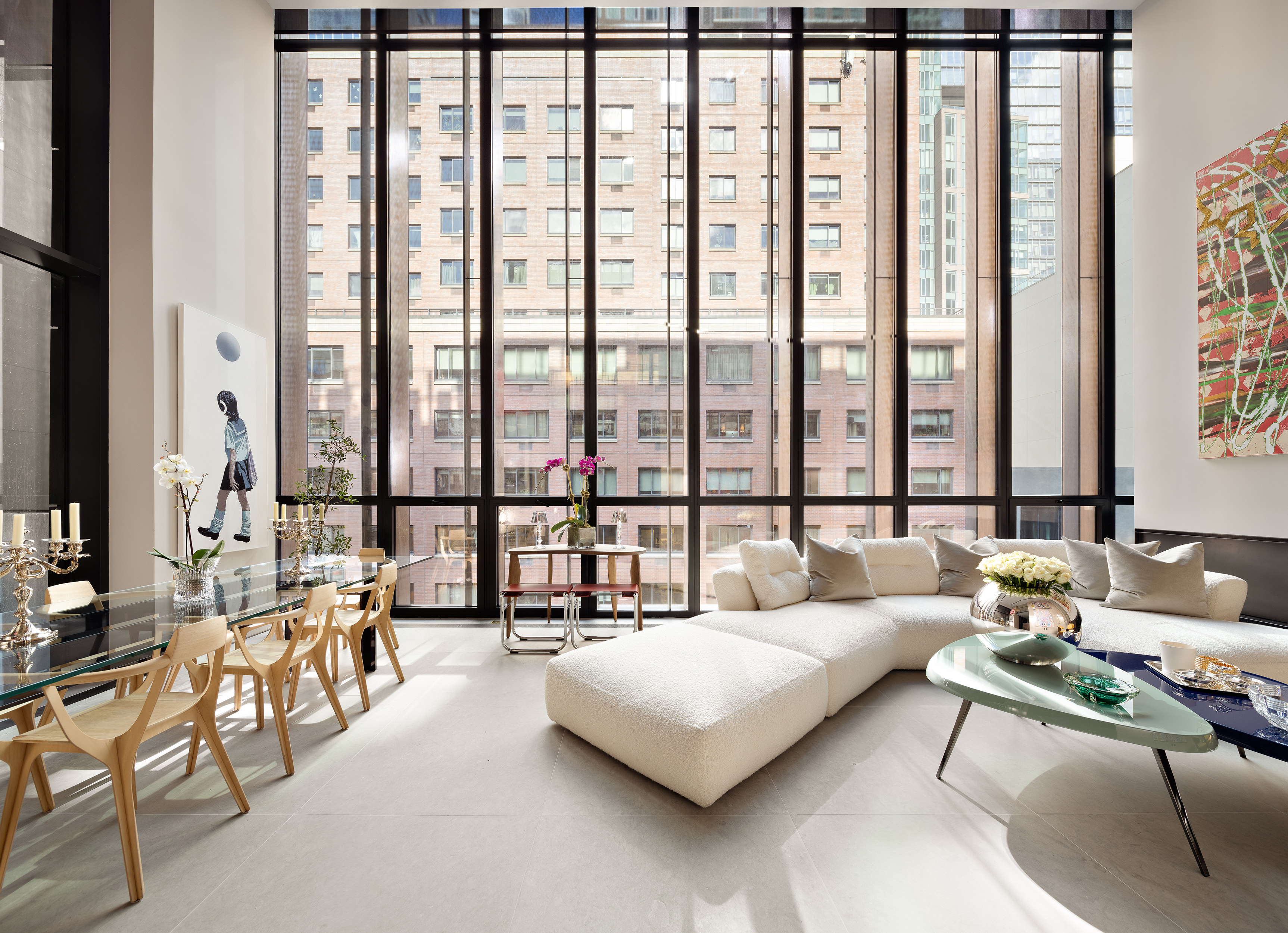 a living room with couches and a large window with outer view