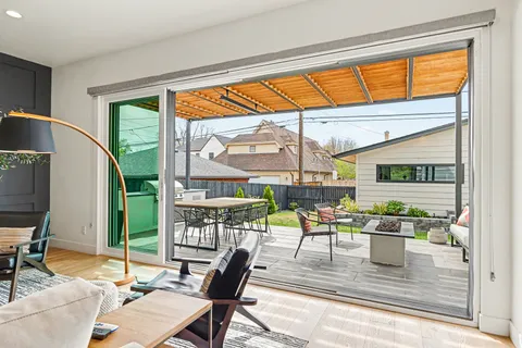 a dining room with furniture water view and a floor to ceiling window