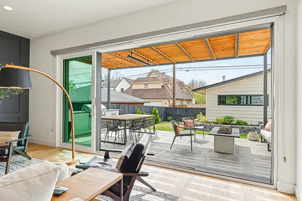a dining room with furniture water view and a floor to ceiling window