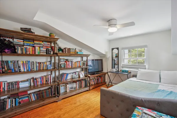 a living room with lots of furniture and a book shelf