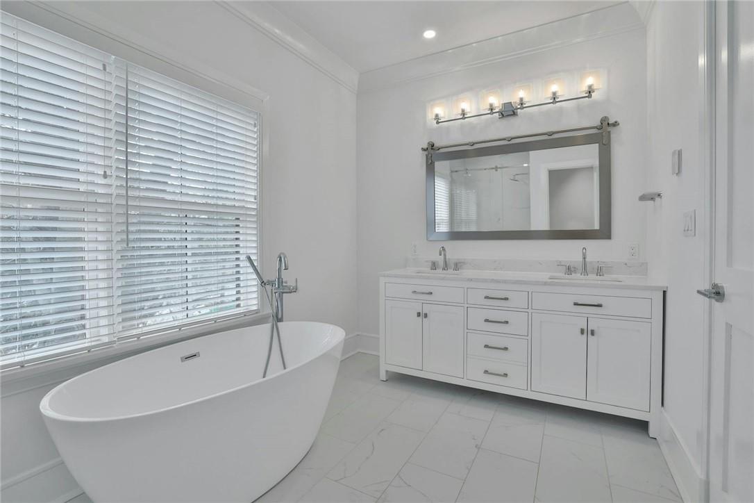 211 Purchase Street, Unit A Rye, NY 10580 - Photo 10 of 22 a bathroom with a tub sink and mirror