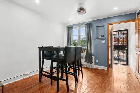 a view of a dining room with furniture and wooden floor