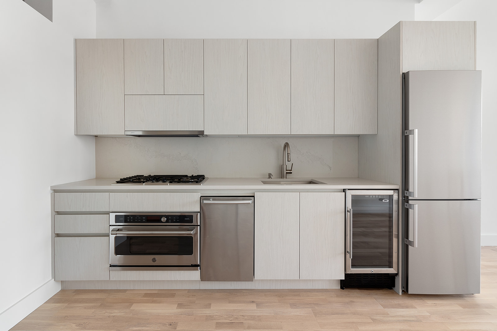 315 7th Avenue, Unit 11E Manhattan, NY 10001 - Photo 3 of 7 a kitchen with a refrigerator stove and white cabinets