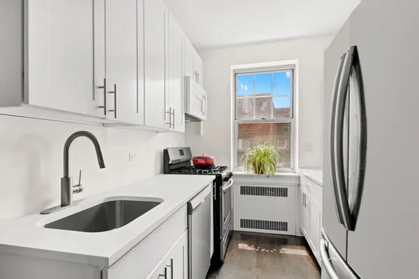 a kitchen with a sink cabinets and stainless steel appliances