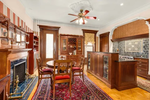 a living room with furniture a fireplace and a chandelier