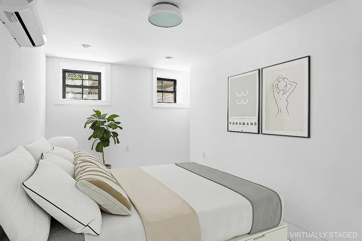 94 Pilling Street, Unit 1 Brooklyn, NY 11207 - Photo 4 of 6 a bedroom with a bed and a potted plant