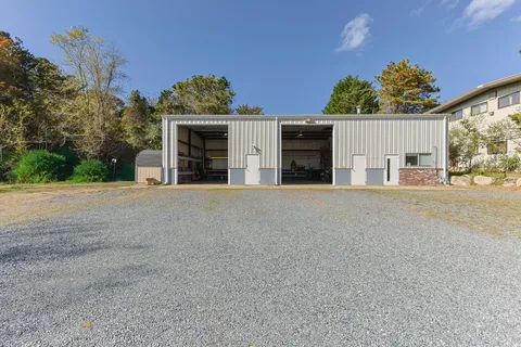 a view of a house with a yard and garage