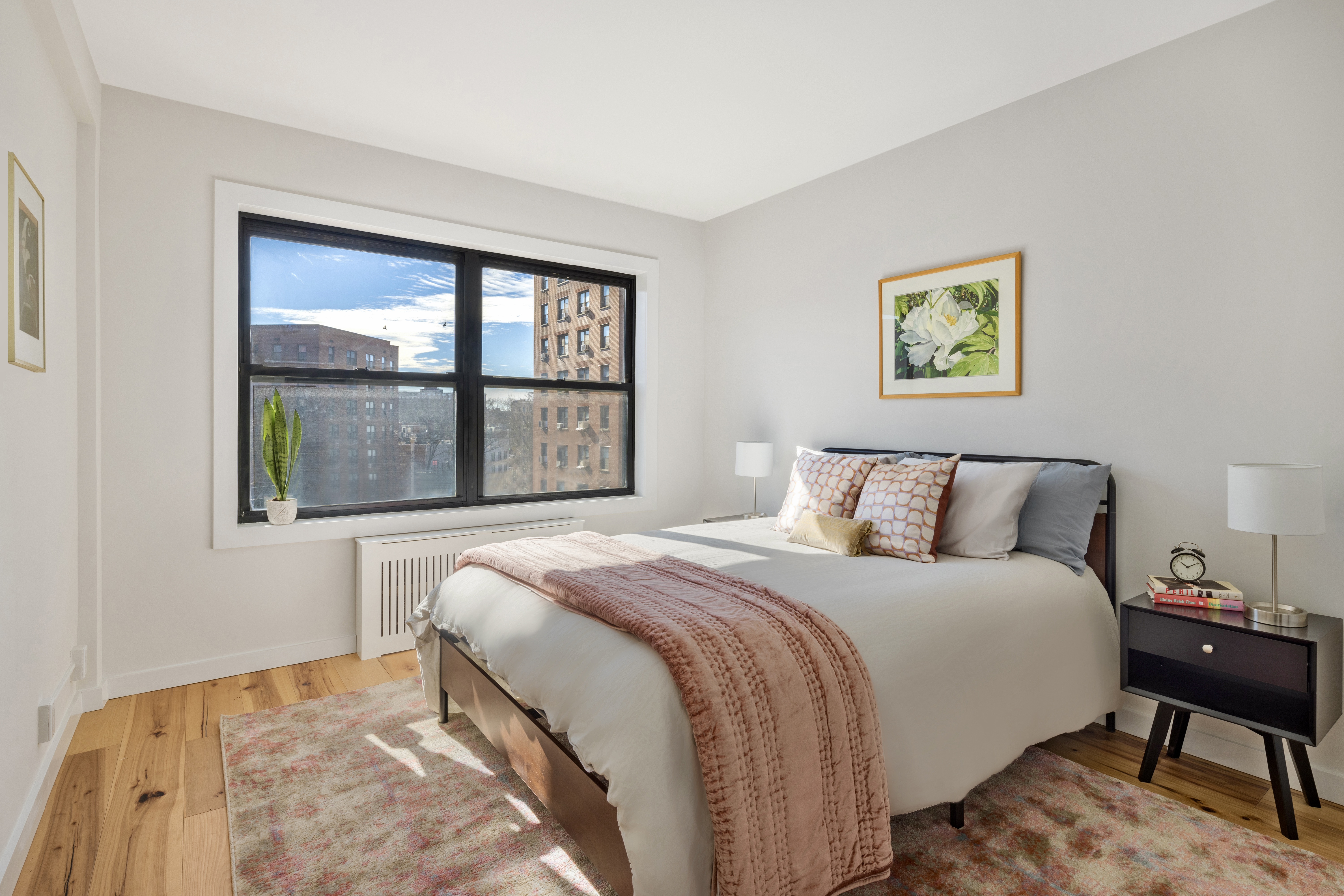 99-72 66th Road, Unit 3R Queens, NY 11374 - Photo 5 of 10 a bedroom with a bed and a painting on the wall
