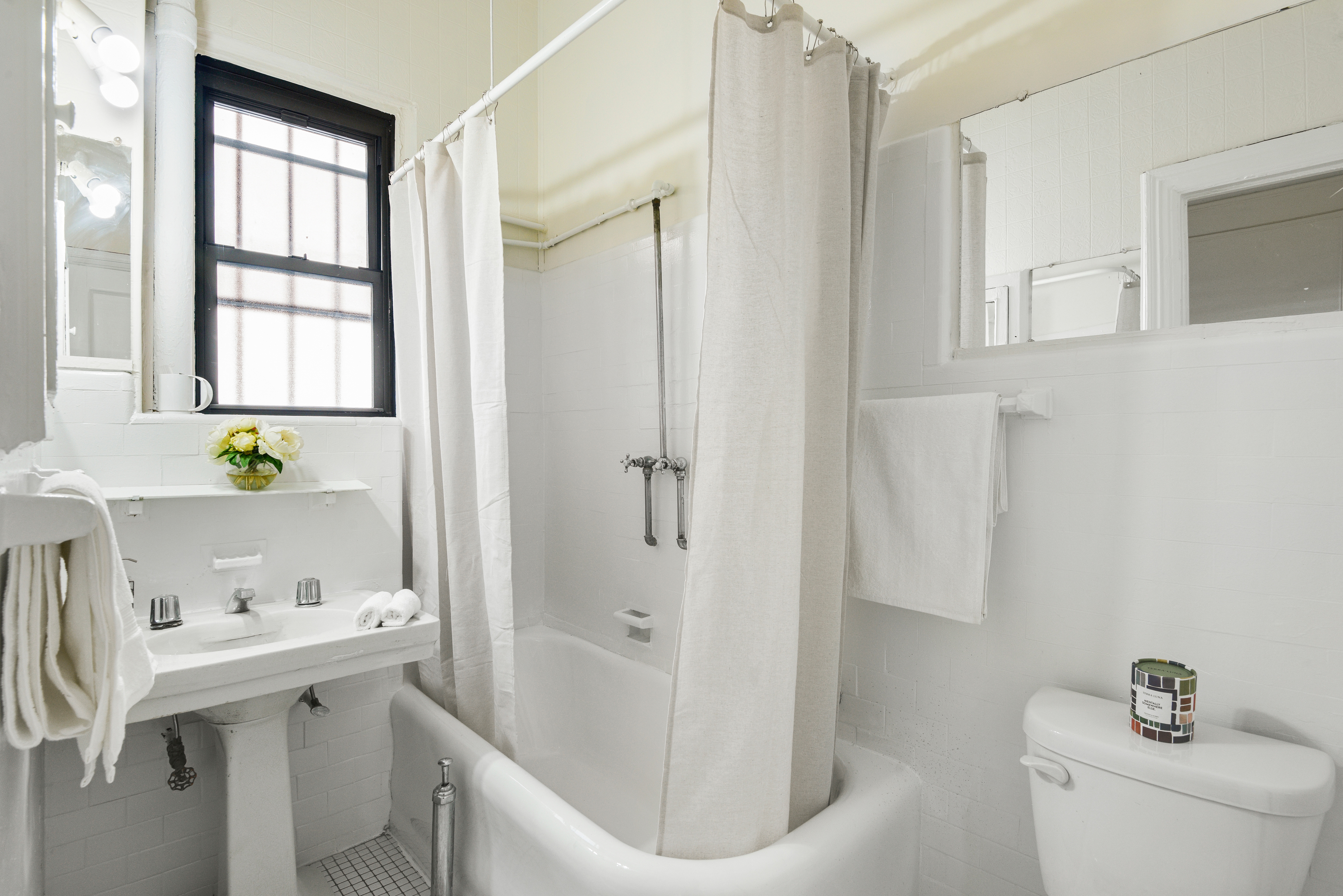 1349 Lexington Avenue, Unit 1F Manhattan, NY 10128 - Photo 7 of 16 a bathroom with a sink a toilet and shower