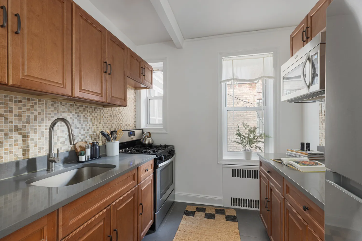 a kitchen with stainless steel appliances granite countertop a sink stove and cabinets