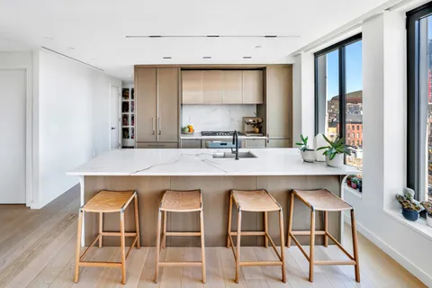 a kitchen with a table chairs sink and cabinets
