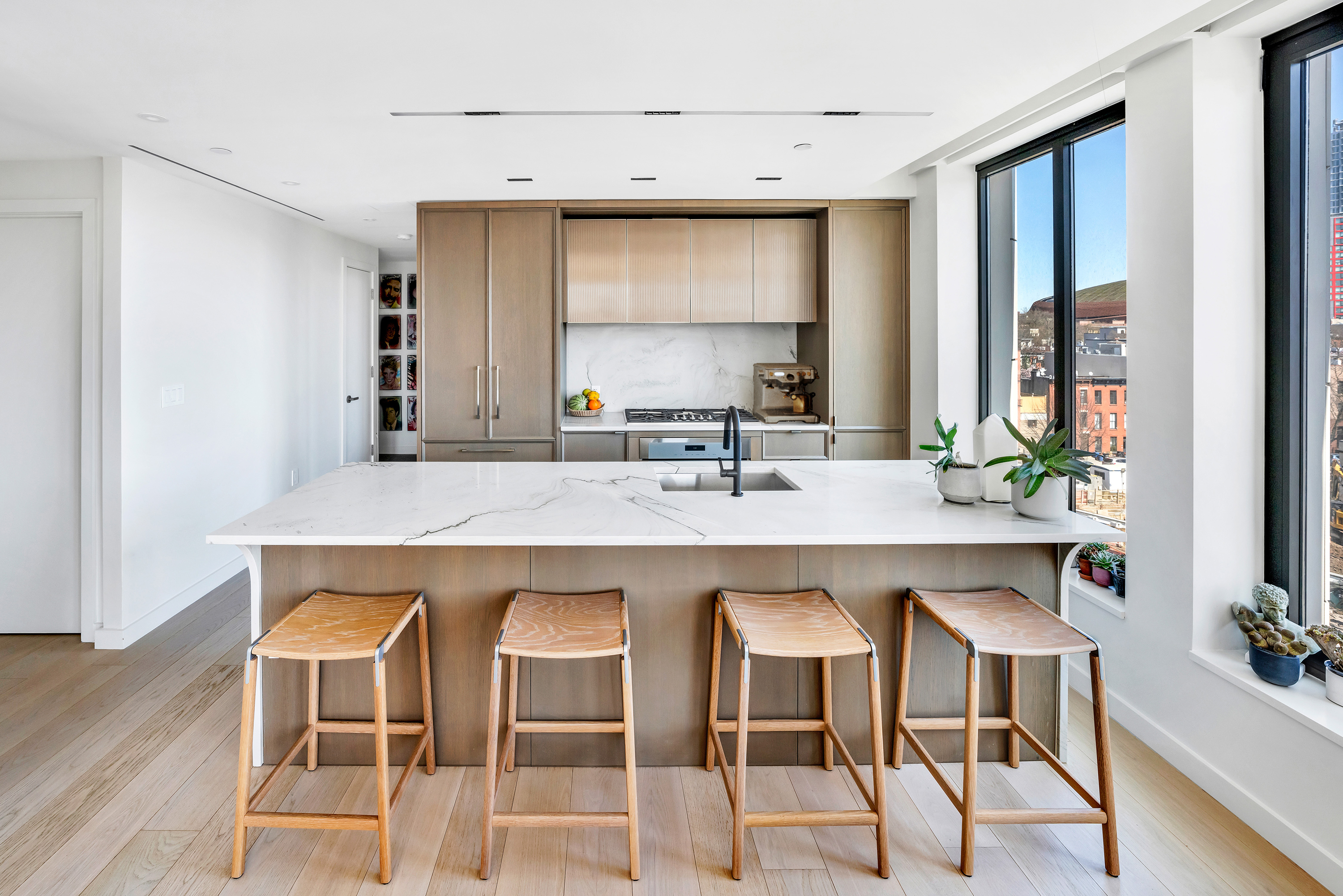 58 St Marks Place, Unit 608 Brooklyn, NY 11217 - Photo 4 of 22 a kitchen with a table chairs sink and cabinets