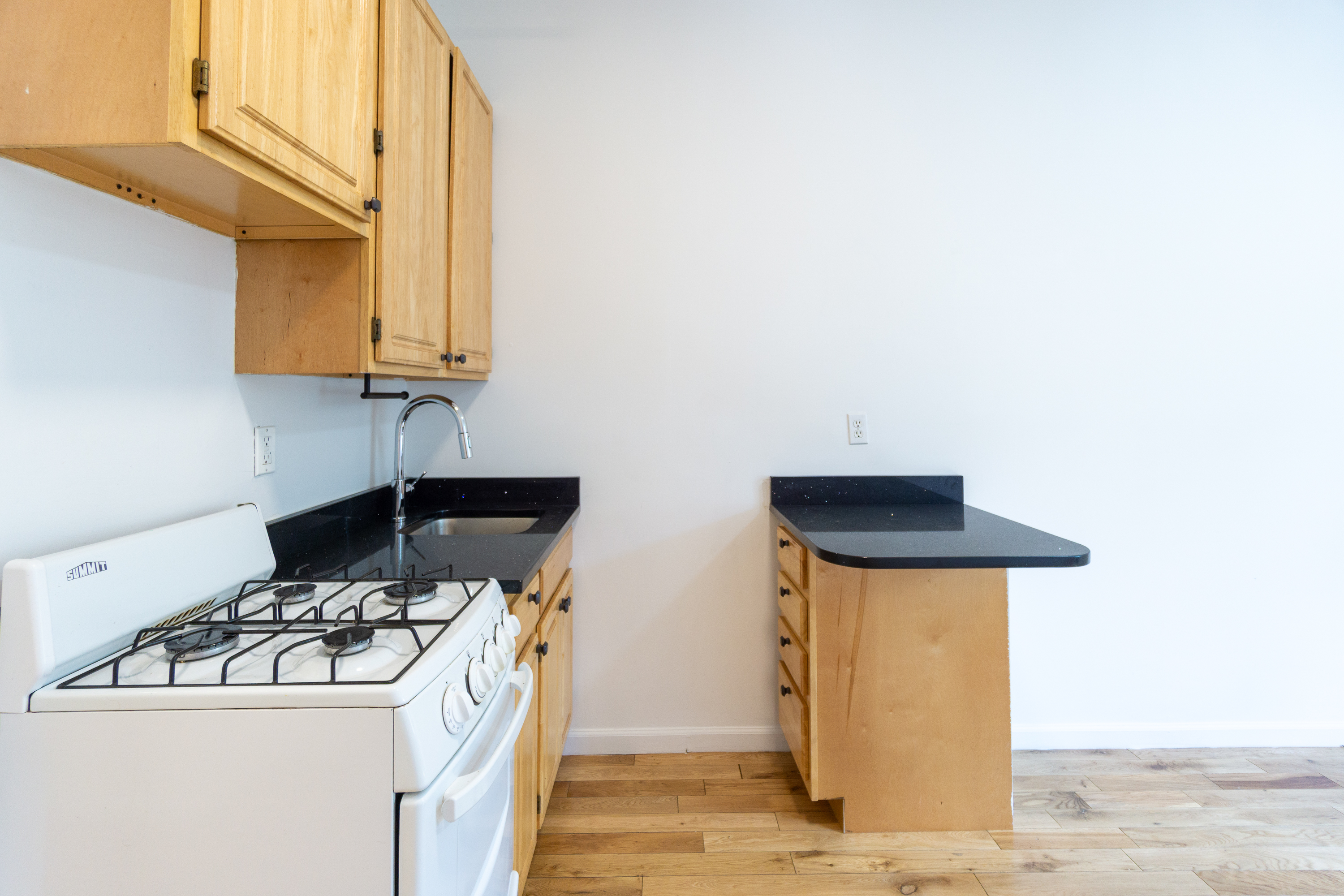 320 West 20th Street, Unit 9 Manhattan, NY 10011 - Photo 4 of 13 a kitchen with stainless steel appliances granite countertop a sink and a stove