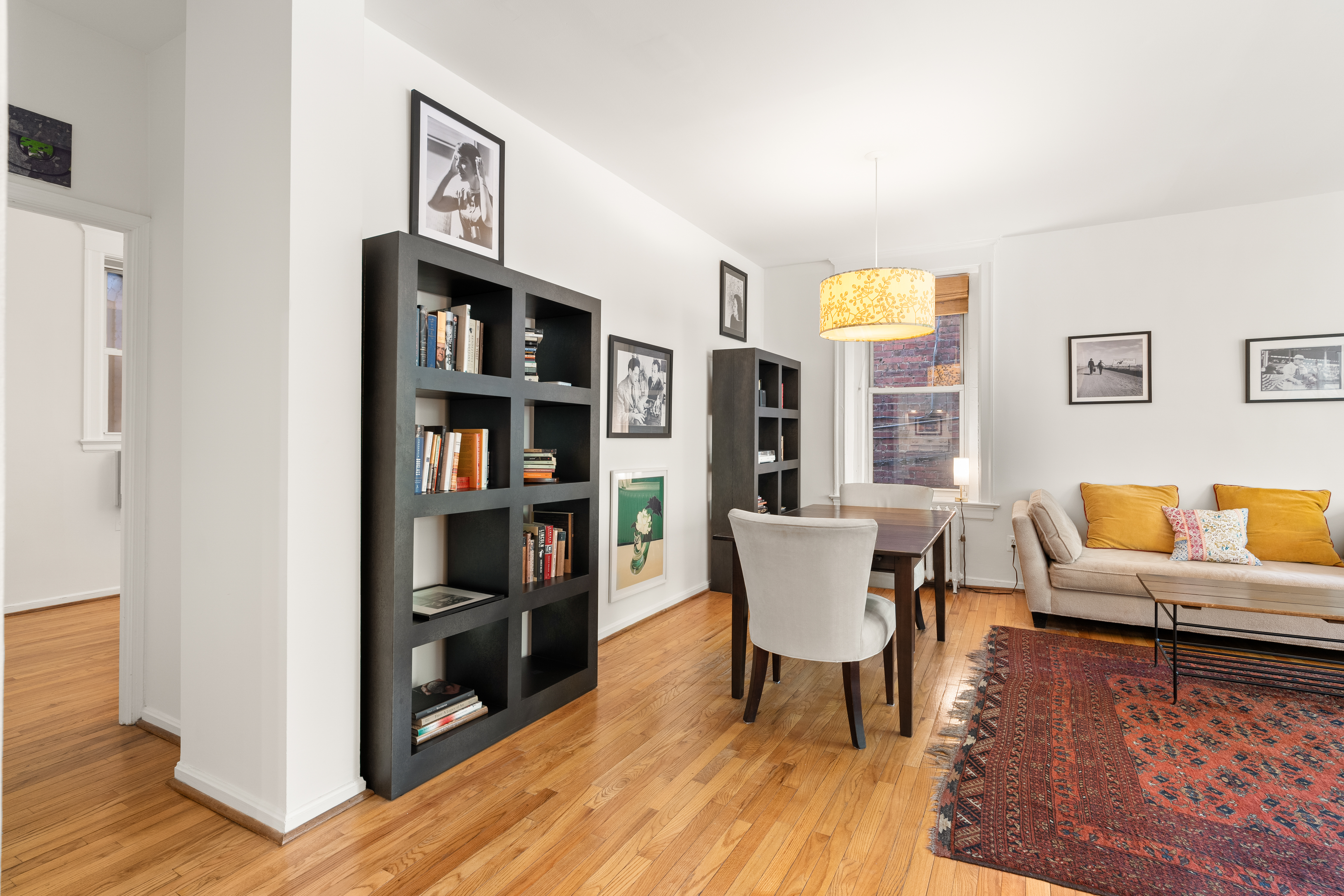 1855 Calvert Street Northwest, Unit 101 Washington, DC 20009 - Photo 4 of 14 a living room with furniture and a book shelf