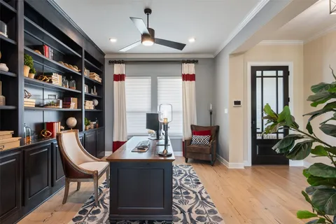 a living room with furniture and a book shelf