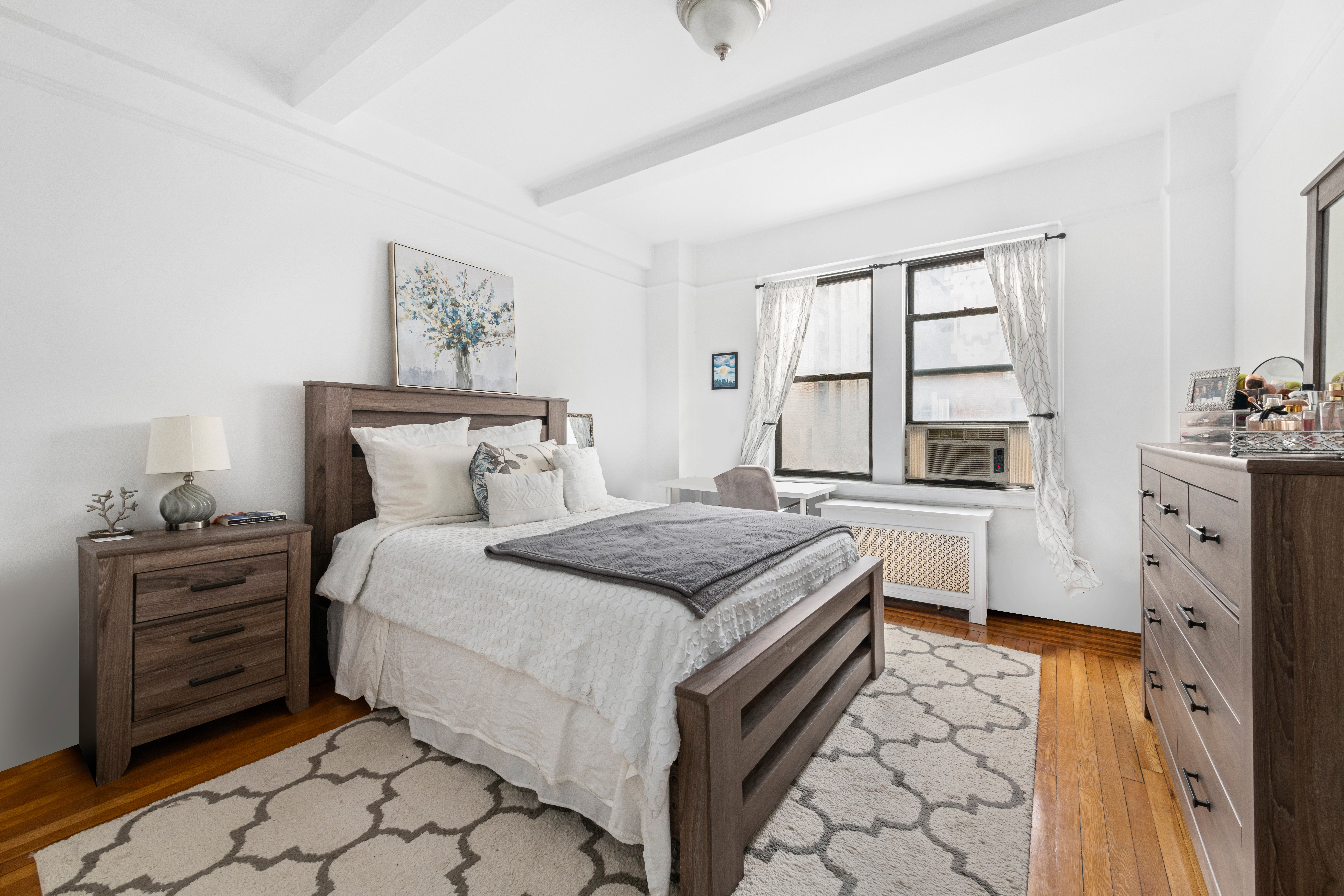 142 East 49th Street, Unit 7B Manhattan, NY 10017 - Photo 3 of 11 a bedroom with a bed and a window