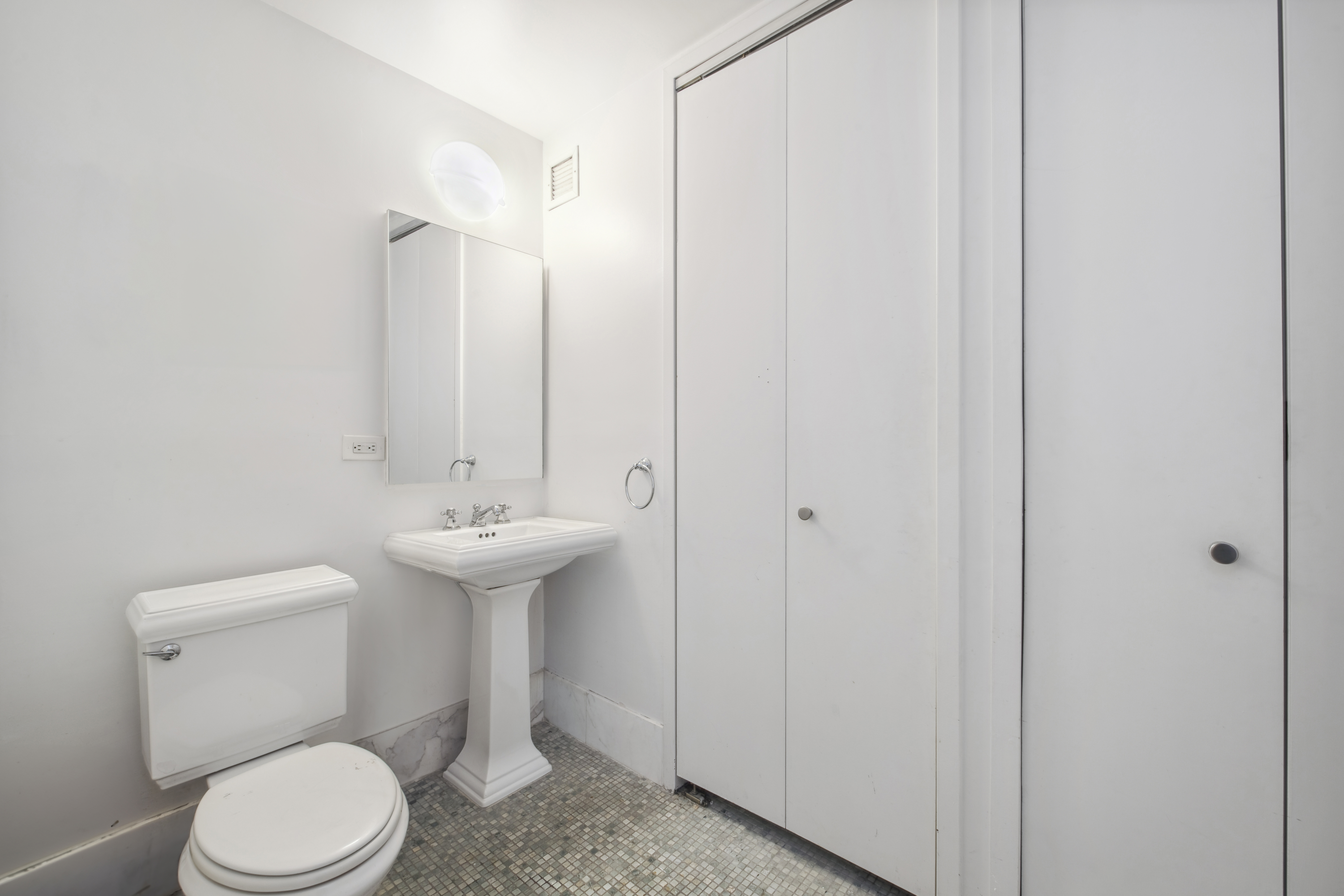151 West 17th Street, Unit 5A Manhattan, NY 10011 - Photo 9 of 11 a bathroom with a sink a toilet and shower
