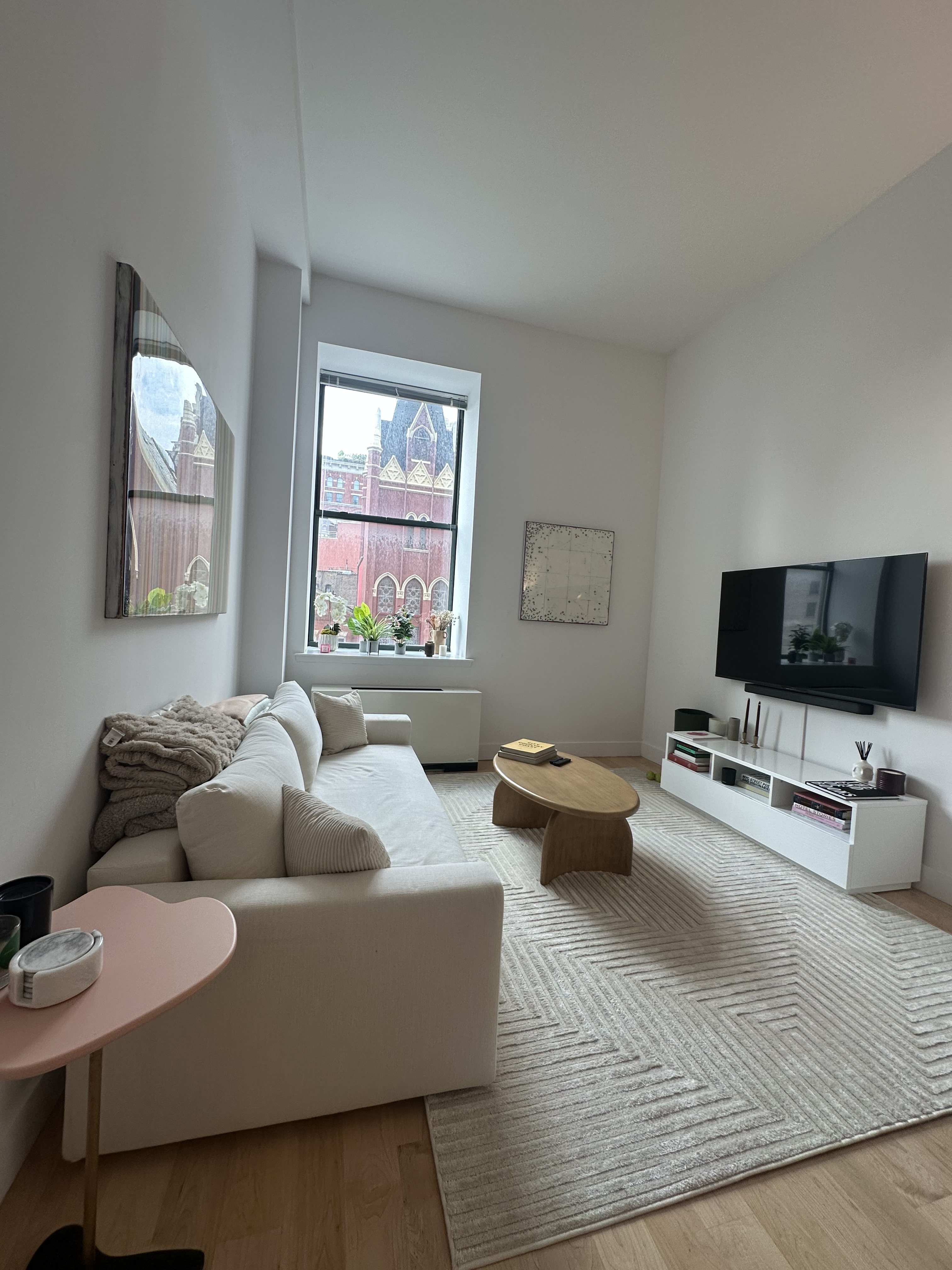 666 Greenwich Street, Unit 350 Manhattan, NY 10014 - Photo 2 of 13 a living room with furniture and a flat screen tv