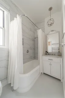a bathroom with a bathtub a sink and a shower
