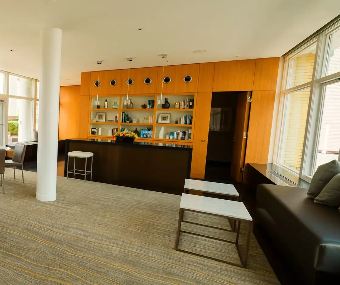 a living room with fireplace furniture and a large window