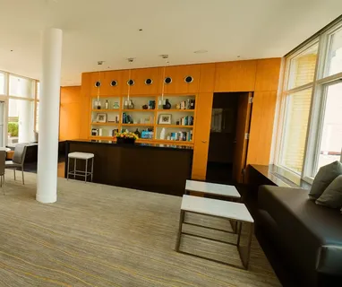 a living room with fireplace furniture and a large window