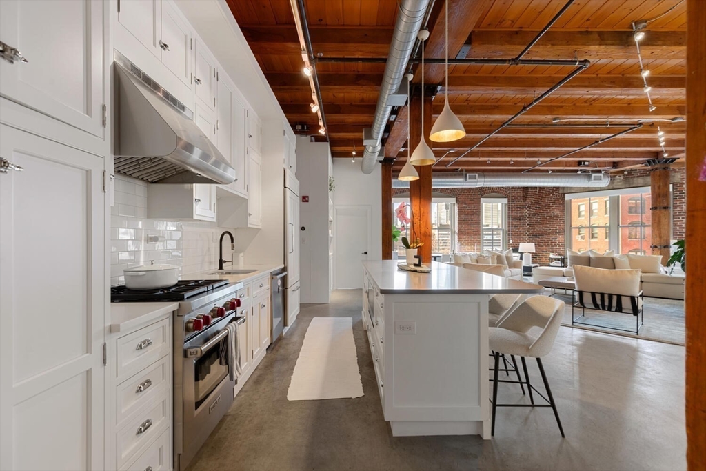 a kitchen with stainless steel appliances granite countertop a stove and cabinets