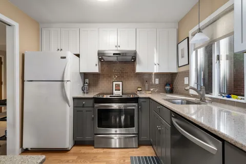 a kitchen with a sink stove and refrigerator